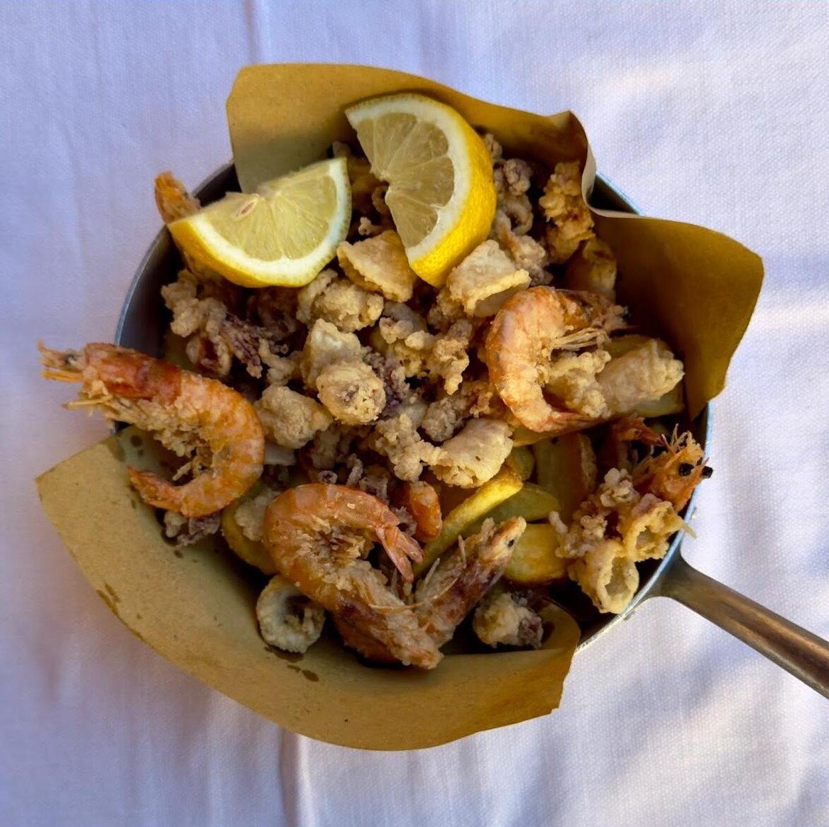 Fritto Misto di mare servito in padellina con limone e patate rustiche fritte